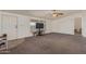 Spacious living room with carpet and large windows providing plenty of natural light at 22216 W Bajada Dr, Wittmann, AZ 85361