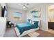 Stylish bedroom featuring a unique bedframe, blue bedding, and a modern aesthetic at 23060 E Sonoqui Blvd, Queen Creek, AZ 85142