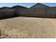 Large vacant backyard with block wall ready for customization and landscaping at 23214 W Miami St, Buckeye, AZ 85326