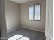 Bedroom with neutral paint, a large window providing natural light, and plush carpeting at 23214 W Miami St, Buckeye, AZ 85326