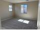 Bedroom with neutral paint, a large window providing natural light, and plush carpeting at 23214 W Miami St, Buckeye, AZ 85326