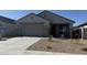 Charming single-story home with a two-car garage, well-maintained landscaping and neutral color palette at 23214 W Miami St, Buckeye, AZ 85326