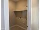 Small laundry room featuring tile flooring, light paint, and a shelf for storage at 23214 W Miami St, Buckeye, AZ 85326