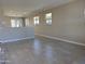 Spacious living room with tile flooring, neutral paint, and large windows provide lots of natural light at 23214 W Miami St, Buckeye, AZ 85326