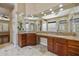 Bathroom featuring double sinks, custom cabinets, and decorative mirrors at 2370 W Maplewood St, Chandler, AZ 85286