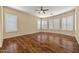 Large bedroom with wood flooring and multiple windows with white shutters at 2370 W Maplewood St, Chandler, AZ 85286