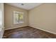 This bedroom features wood flooring and a window with white shutters at 2370 W Maplewood St, Chandler, AZ 85286