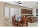 Elegant dining room featuring a wooden table set, ceiling fan, plantation shutters, and natural light at 2370 W Maplewood St, Chandler, AZ 85286