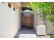 Inviting double front door with stone accents, complemented by mature landscaping at 2370 W Maplewood St, Chandler, AZ 85286