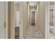Hallway featuring tile flooring and views into other rooms at 2370 W Maplewood St, Chandler, AZ 85286