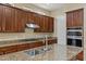 Close-up of a kitchen island showcasing granite countertops, stainless steel sink, and modern faucet at 2370 W Maplewood St, Chandler, AZ 85286