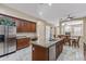 Open concept kitchen with a center island, wood cabinets, granite counters, and stainless steel appliances at 2370 W Maplewood St, Chandler, AZ 85286