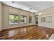 Bright living room featuring hardwood floors, a decorative light fixture, and large windows at 2370 W Maplewood St, Chandler, AZ 85286