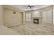Cozy living room features a fireplace with stone surround, tile floors, and bright windows at 2370 W Maplewood St, Chandler, AZ 85286