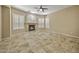 Bright living room featuring a fireplace, tile floors, and large windows with plantation shutters at 2370 W Maplewood St, Chandler, AZ 85286