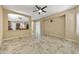 Spacious living area with tile flooring, ceiling fan, and open access to the dining and kitchen areas at 2370 W Maplewood St, Chandler, AZ 85286