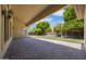 A spacious covered patio with brick pavers and an arched entrance to the lawn, perfect for outdoor entertaining at 2370 W Maplewood St, Chandler, AZ 85286