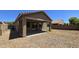 Desert backyard with covered patio, rock landscaping, and block wall at 23853 W Hammond Ln, Buckeye, AZ 85326
