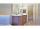 A spacious bathroom with double vanity, wooden cabinets, and tile flooring at 23853 W Hammond Ln, Buckeye, AZ 85326
