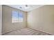 Comfortable bedroom with a neutral color scheme, carpeted floor, and a window for natural light at 23853 W Hammond Ln, Buckeye, AZ 85326