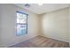 A bright bedroom with a window overlooking the outdoors, beige walls, and carpet flooring at 23853 W Hammond Ln, Buckeye, AZ 85326