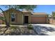Charming single-story home with a brick facade, desert landscaping, and a two-car garage at 23853 W Hammond Ln, Buckeye, AZ 85326