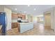 Open kitchen featuring an island, stainless steel appliances, and seamless flow to the dining area at 23853 W Hammond Ln, Buckeye, AZ 85326