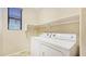 Convenient laundry room with washer, dryer, and ample shelving for storage at 23853 W Hammond Ln, Buckeye, AZ 85326