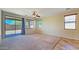 Spacious main bedroom with multiple windows, a sliding glass door, ceiling fan and plush carpeting at 23853 W Hammond Ln, Buckeye, AZ 85326