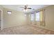 Main bedroom with a ceiling fan, carpet flooring, and multiple windows with blinds at 23853 W Hammond Ln, Buckeye, AZ 85326