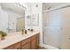 Bathroom with a single sink vanity, framed mirror, and glass enclosed shower at 255 S Kyrene Rd # 139, Chandler, AZ 85226
