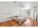 Bright bedroom featuring a ceiling fan, large window, and wood flooring at 255 S Kyrene Rd # 139, Chandler, AZ 85226