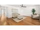 Spacious living room showcasing hardwood floors, a comfortable sofa, and bright white walls at 255 S Kyrene Rd # 139, Chandler, AZ 85226