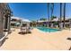 Exterior image of the community pool with tables, lounge chairs, and several tall palm trees at 255 S Kyrene Rd # 139, Chandler, AZ 85226