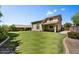 Beautiful backyard with green grass, block wall and covered patio perfect for outdoor entertaining at 31133 N 132Nd Ln, Peoria, AZ 85383