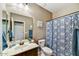 Bathroom featuring floral shower curtain, vanity, and mirror at 31133 N 132Nd Ln, Peoria, AZ 85383
