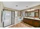 Bathroom featuring glass enclosed shower, soaking tub, and dual sinks at 31133 N 132Nd Ln, Peoria, AZ 85383