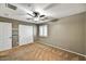Bedroom features a ceiling fan, window with shutters and a double door closet at 31133 N 132Nd Ln, Peoria, AZ 85383