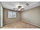 Neutral bedroom featuring carpet flooring, ceiling fan, and shuttered window at 31133 N 132Nd Ln, Peoria, AZ 85383