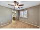 Neutral bedroom with view to the bathroom, ceiling fan, and plantation shutters at 31133 N 132Nd Ln, Peoria, AZ 85383