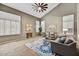 Bright living room with vaulted ceilings, large windows, and stylish decor at 31133 N 132Nd Ln, Peoria, AZ 85383