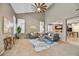 Comfortable living room with high ceilings, large windows, and stylish furniture at 31133 N 132Nd Ln, Peoria, AZ 85383