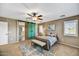 Main bedroom features sliding barn door, bench seat, and plantation shutters at 31133 N 132Nd Ln, Peoria, AZ 85383