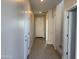 Inviting hallway features neutral colored walls, wood-style tile flooring, and access to various rooms at 3125 S 232Nd Ave, Buckeye, AZ 85326