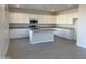Modern kitchen featuring white cabinetry, stainless steel appliances, and a center island with granite countertops at 3125 S 232Nd Ave, Buckeye, AZ 85326