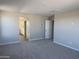 Open Primary bedroom with ensuite bathroom access and comfortable carpet flooring at 3125 S 232Nd Ave, Buckeye, AZ 85326