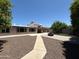 Backyard featuring a fire pit, artificial turf, rock landscaping, and the back of the house in the background at 3145 W Acoma Dr, Phoenix, AZ 85053