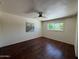 Bedroom with wood-look floors, ceiling fan, and natural light at 3145 W Acoma Dr, Phoenix, AZ 85053