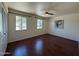Bedroom with wood-look floors, natural light, and ceiling fan at 3145 W Acoma Dr, Phoenix, AZ 85053