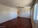 Bedroom with wood-look floors, closet space, and ceiling fan at 3145 W Acoma Dr, Phoenix, AZ 85053